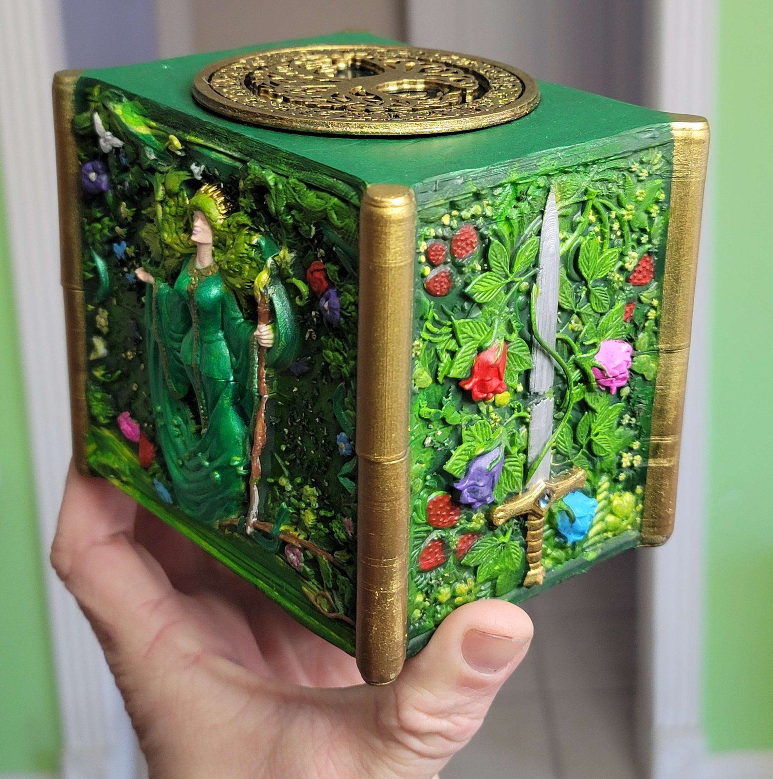The forest deck box at an angle: the goddess, the sword and the lid medallion