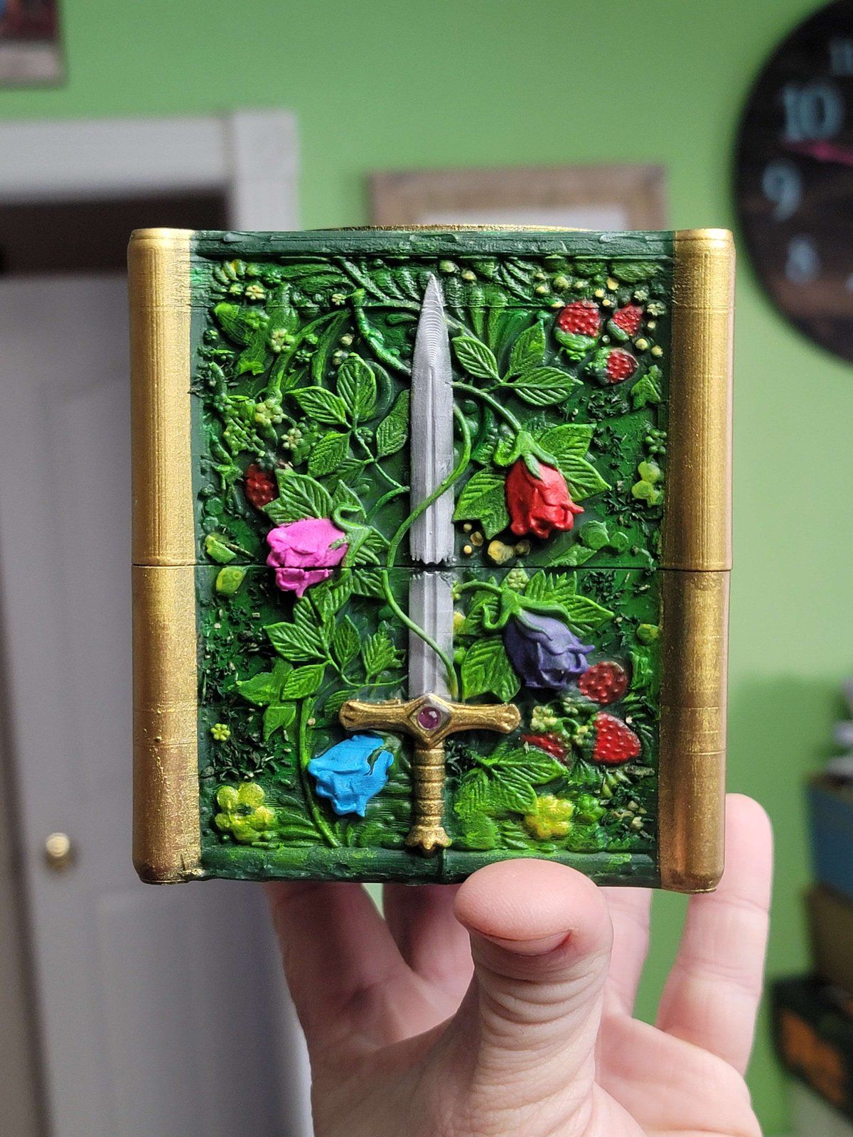 The forest deck box’s sword panel, wrapped in leaves, roses and flowers