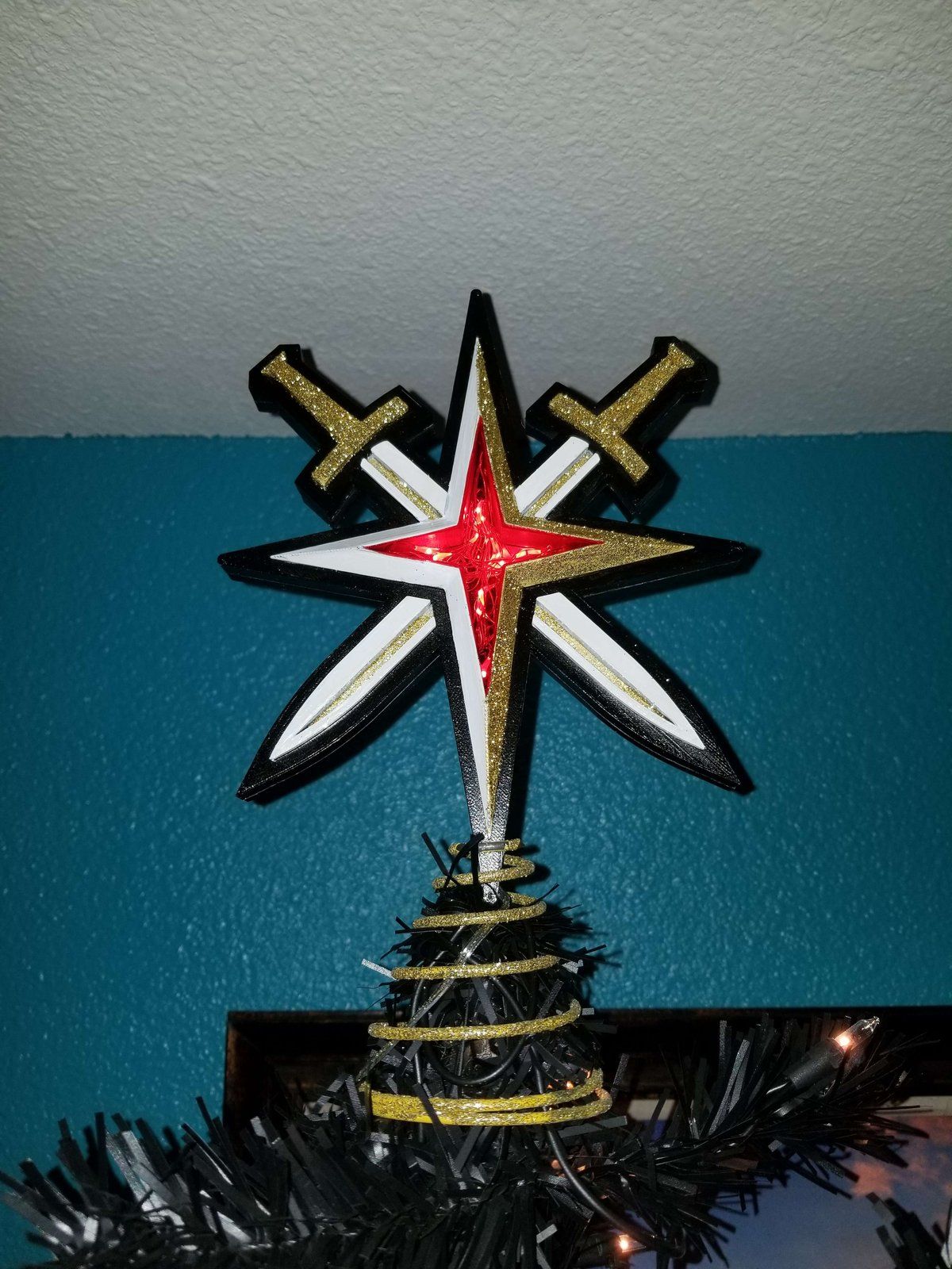 A Golden Knights tree topper: a star with crossed swords, 2018