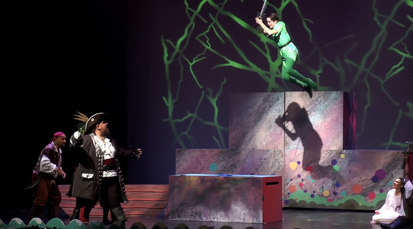 Peter Pan flies above the set while Captain Hook’s crew looks on