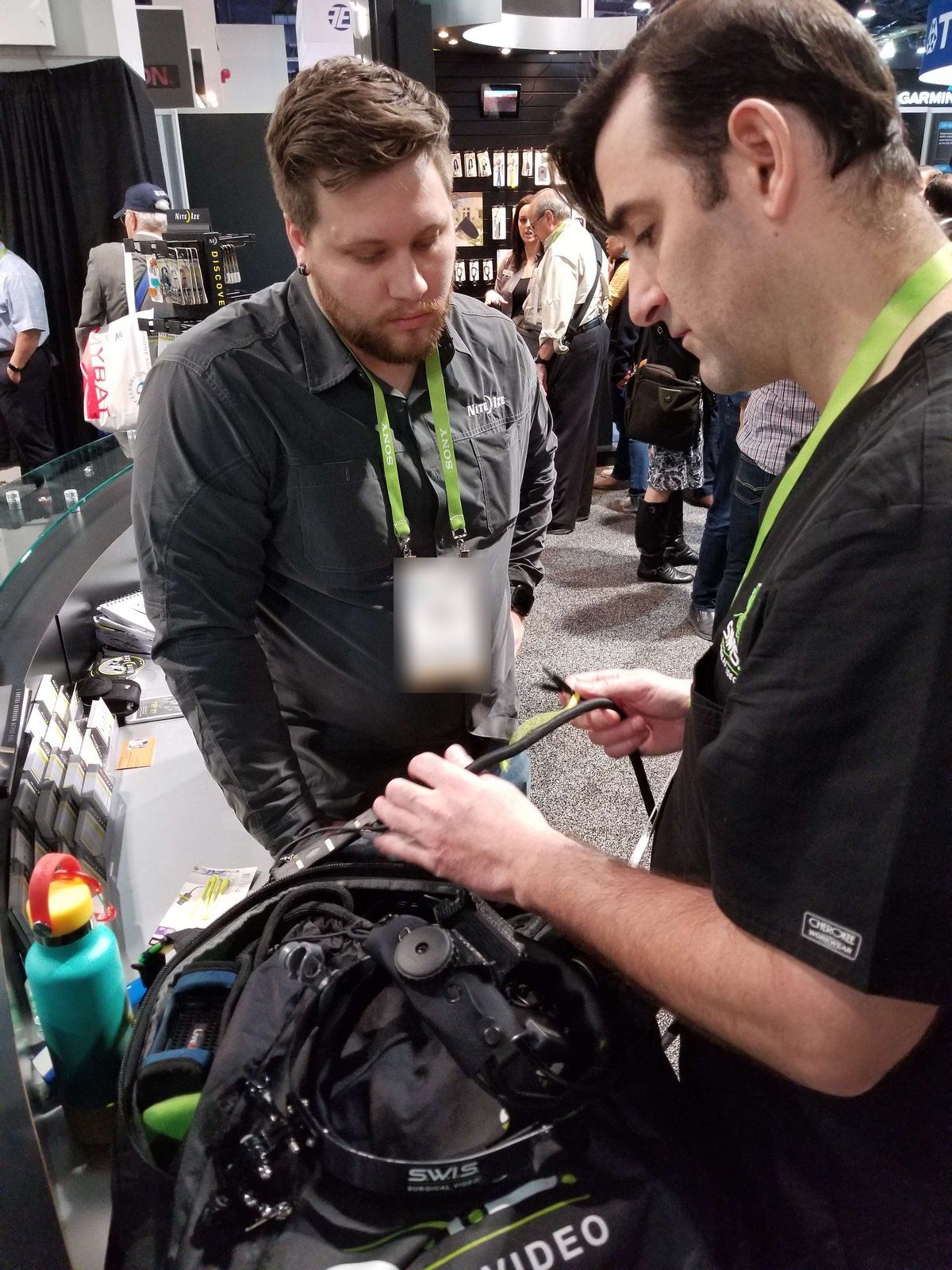 Dr. Ryan Grabow (right) with the S.W.I.S. headset at CES 2018